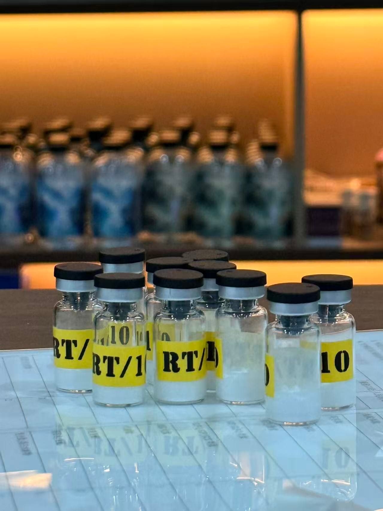 Cupratec lot-release bench — copper-peptide vials photographed under the inspection lamp, every label corresponding to a lot-specific UV-Vis spectrum and Cu²⁺ : peptide ratio report.